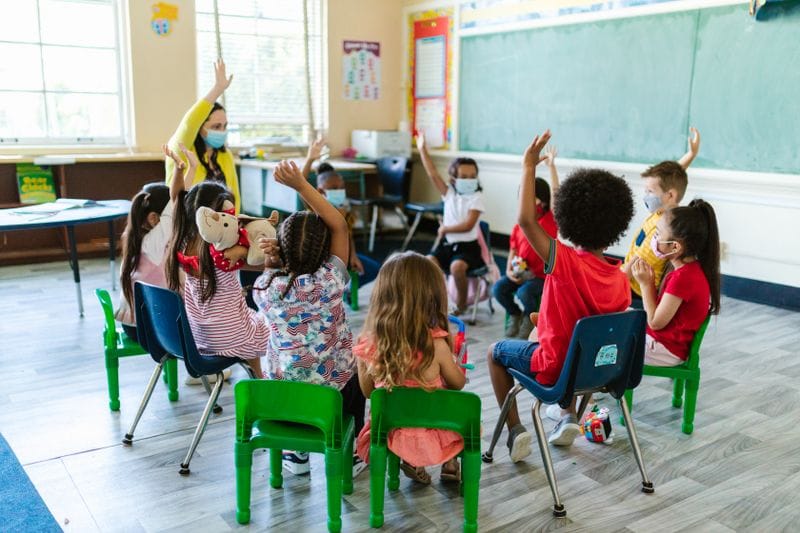 Teacher reading story to children